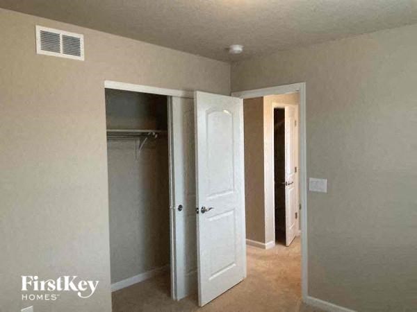 an empty room with a closet and a white door