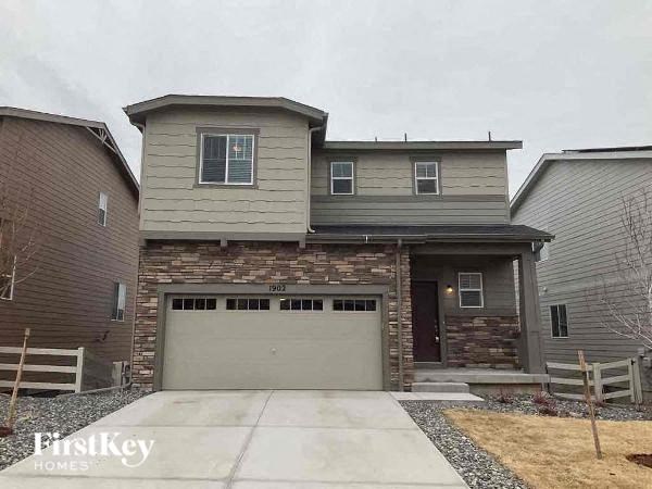 a house with a garage door in front of it