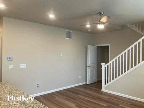 a living room with a staircase and a white door
