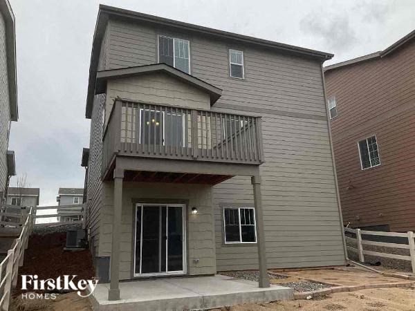a white house with a balcony and a deck
