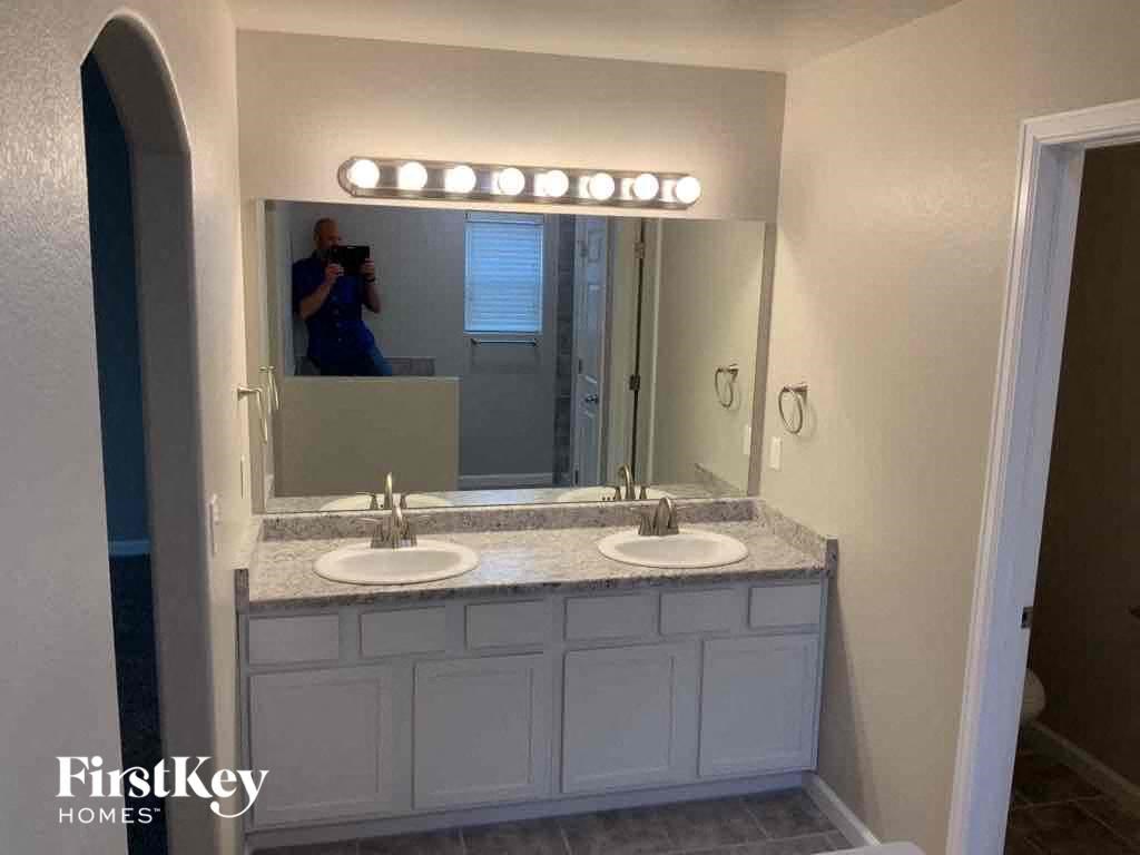 a bathroom with two sinks and a large mirror