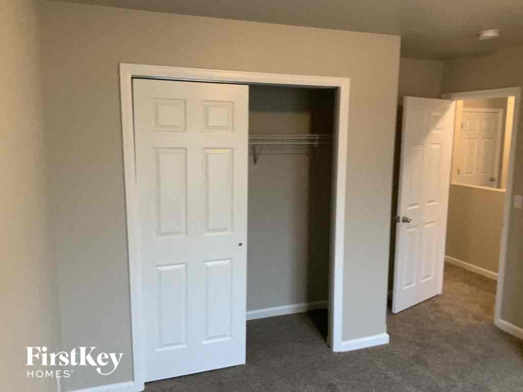 an empty closet in a room with a white door