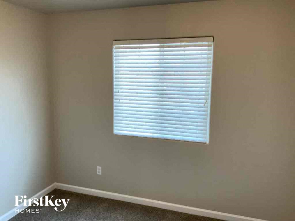 a room with a window with blinds on it