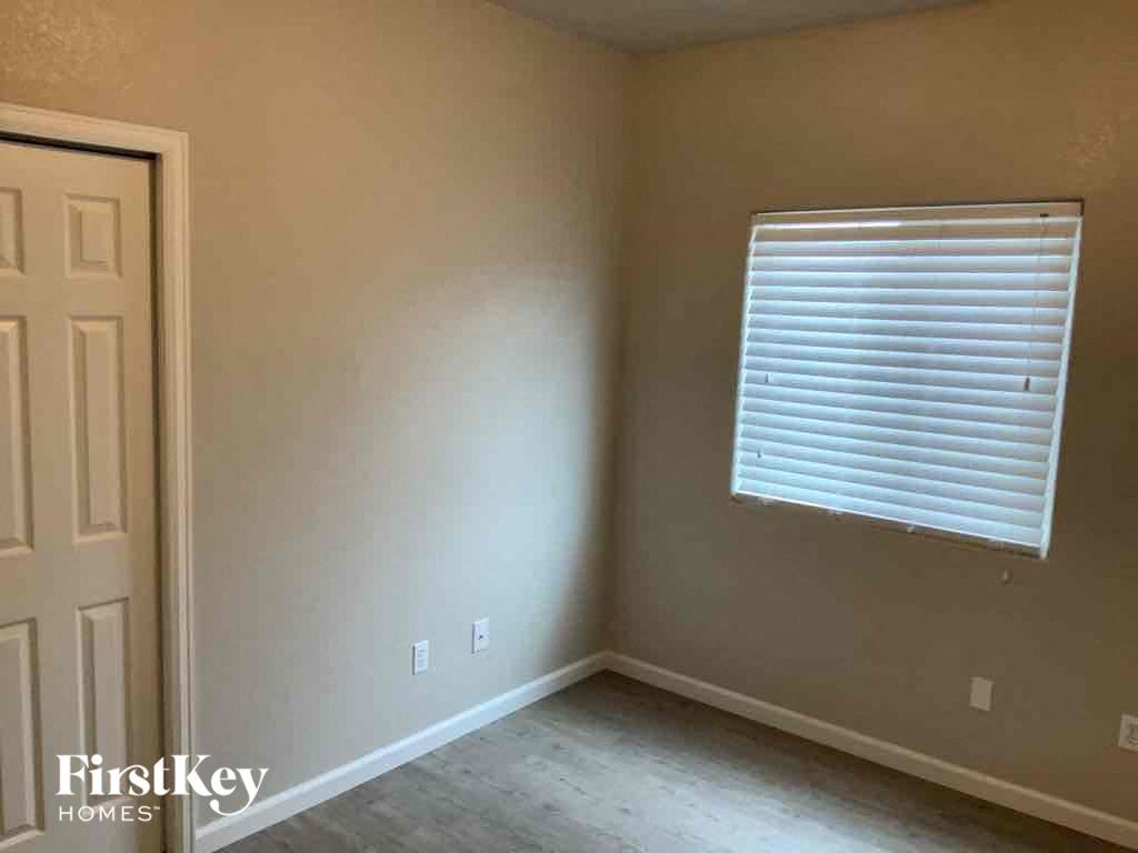 an empty room with a window and a door