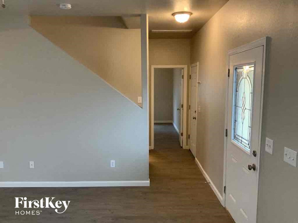 a hallway with a white door and a hall way and a door with a window
