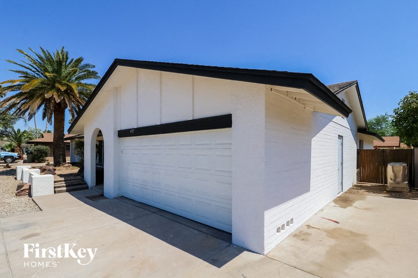 the front of a garage with a white garage door
