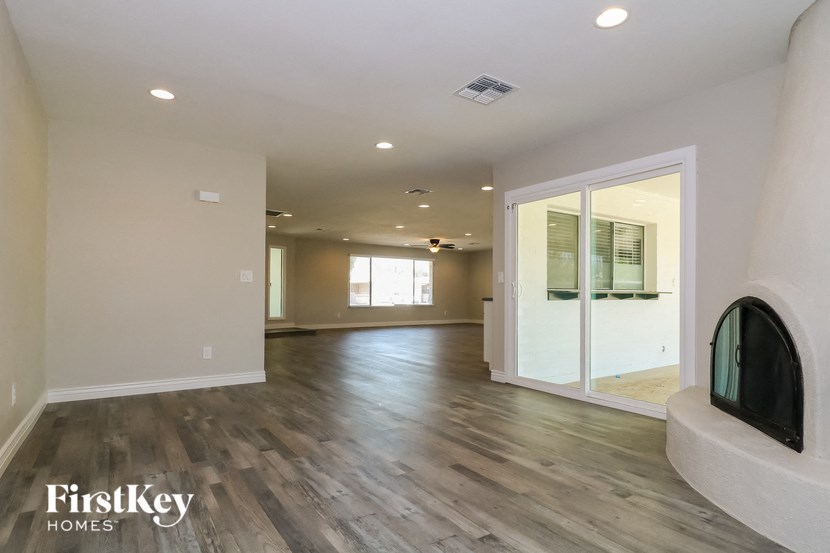 a living room with a fireplace and a large glass door