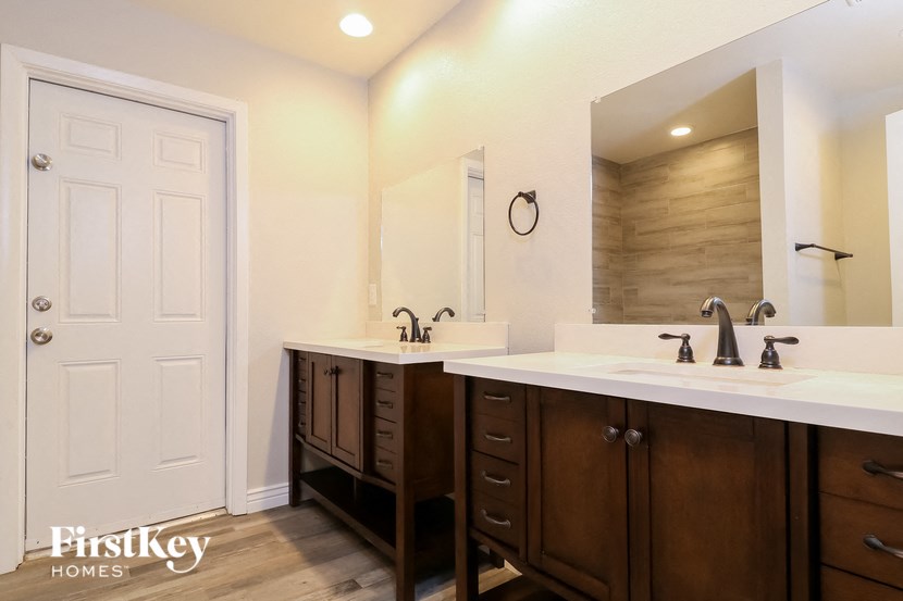 a bathroom with two sinks and a mirror