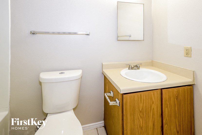 A white toilet sits next to a sink in a small bathroom.