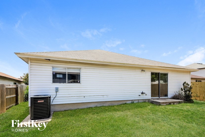 A white house with a brown door and a small porch.