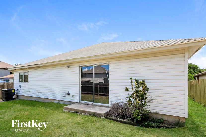 A small white house with a FirstKey Homes logo.