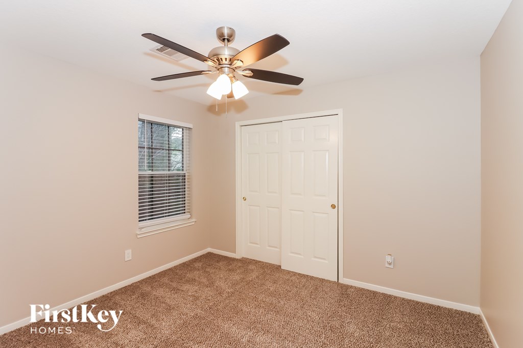 A room with a fan and a door.