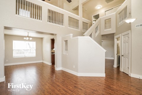 the living room and dining room of an open floor plan