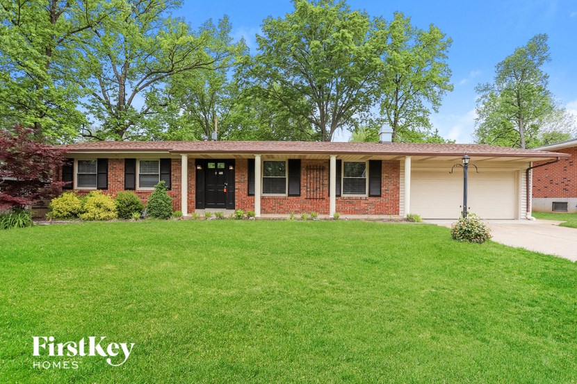 a brick house with a lawn in front of it