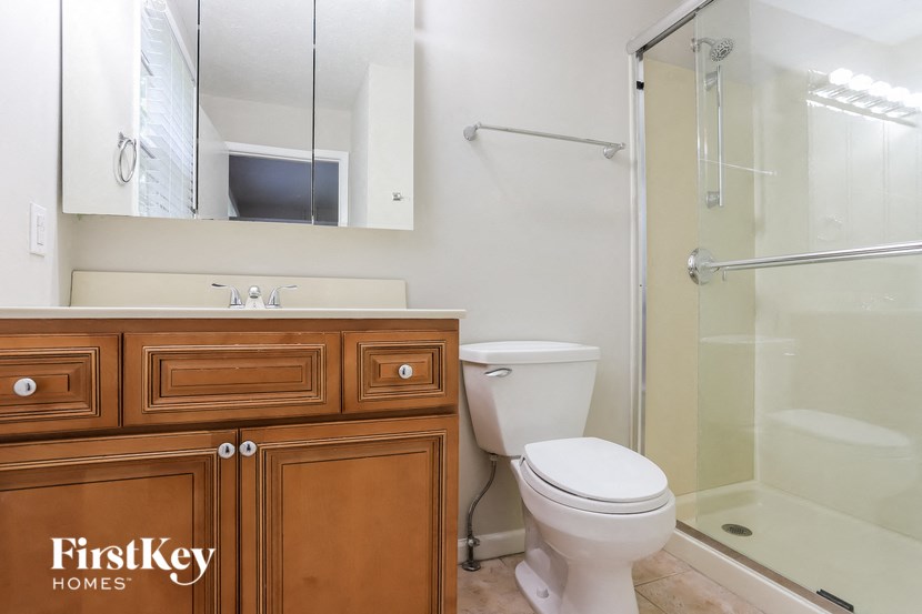 a bathroom with a toilet and a sink and a shower