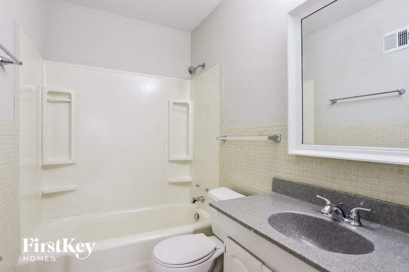 a bathroom with a sink toilet and a bath tub