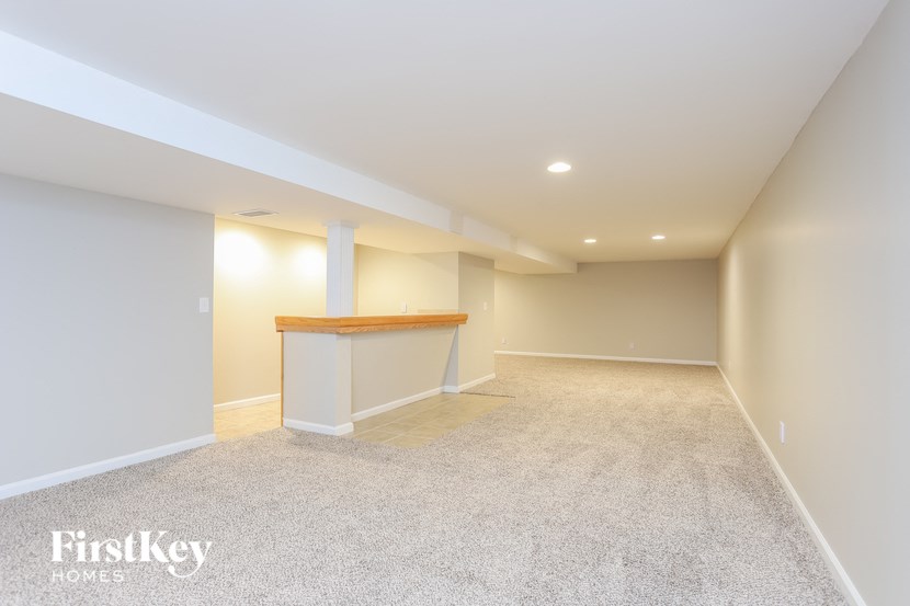an empty basement with a counter in the middle