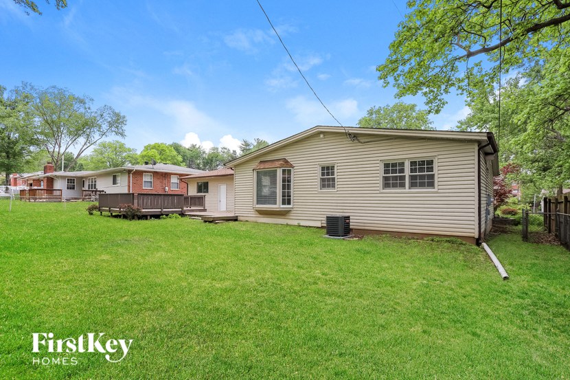 a home with a yard and some houses in the background