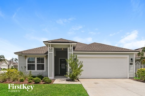 A house with a garage door and a front door is shown.
