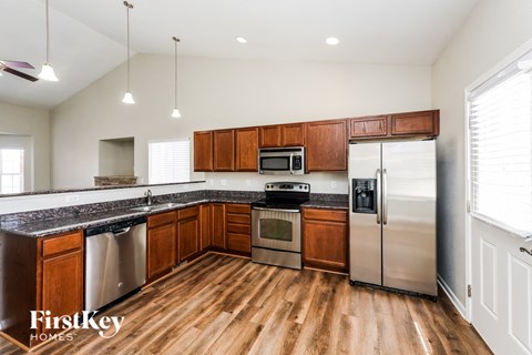 A kitchen with wooden cabinets and stainless steel appliances.