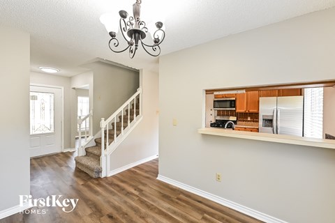 the living room is open to the kitchen and dining room