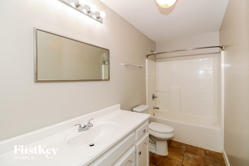 a bathroom with a sink and a toilet and a shower