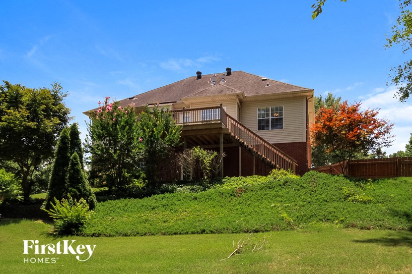 a house with a deck on top of a hill