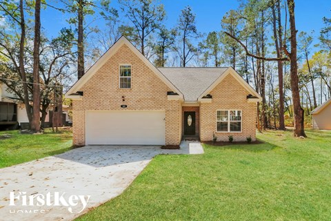 A brick house with a garage is for sale.