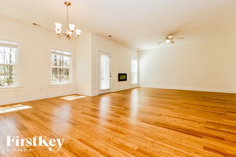 A room with wooden floors and a chandelier.