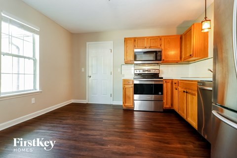 A kitchen with wooden cabinets and stainless steel appliances.