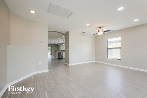 A spacious room with a FirstKey Homes logo on the bottom left corner.