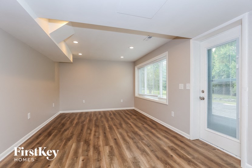 A room with wooden floors and a slanted ceiling.
