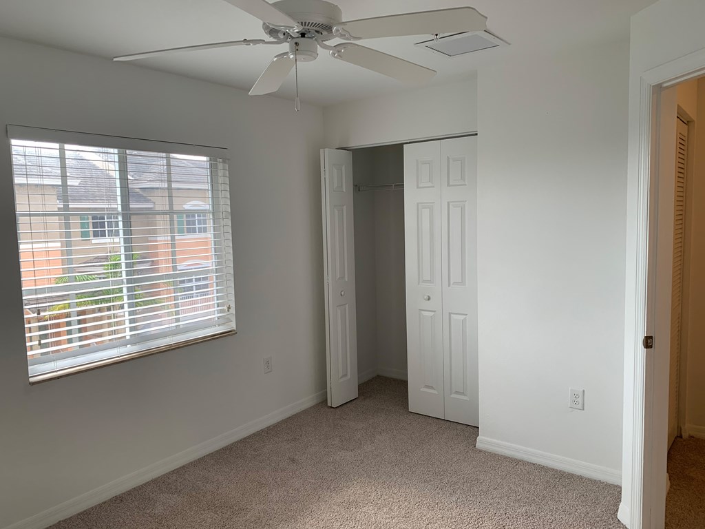 Preserve at Boynton Beach apartment home bedroom with ceiling fan and carpeting