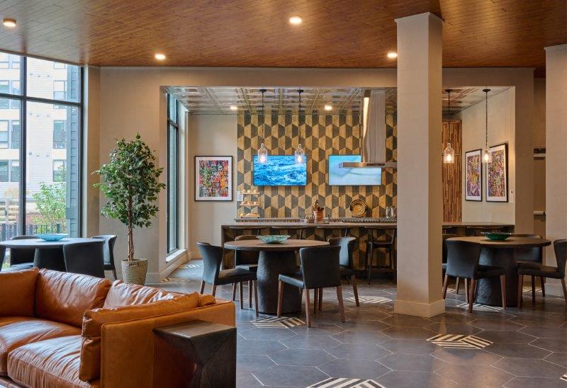 the lobby of a restaurant with a bar and couches