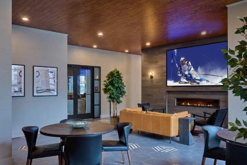 a living room with a tv and a table and chairs