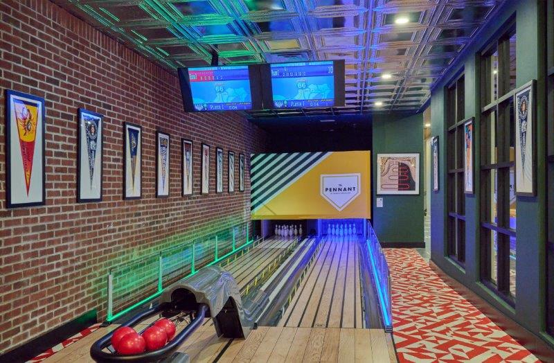 a bowling alley in a building with a bowl of apples