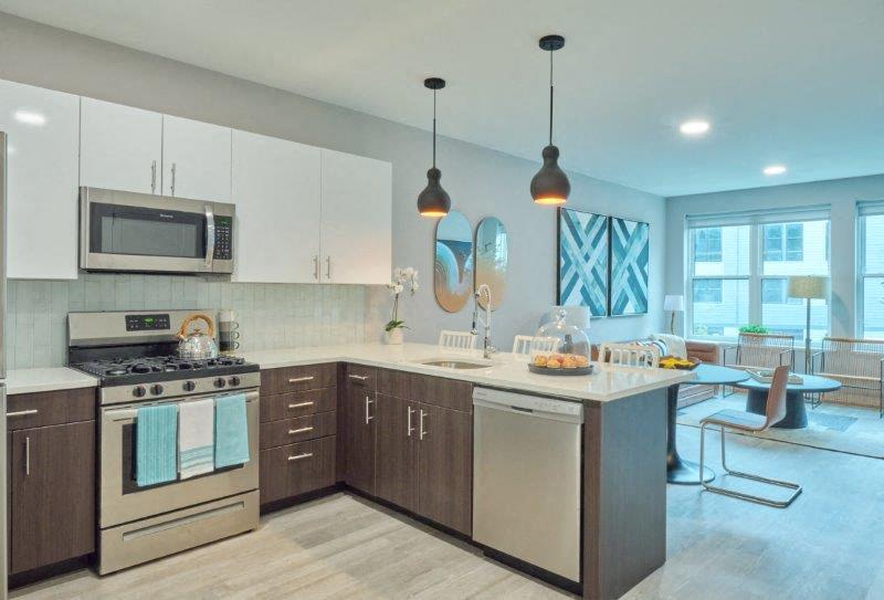 a kitchen with an island and a stove and a microwave