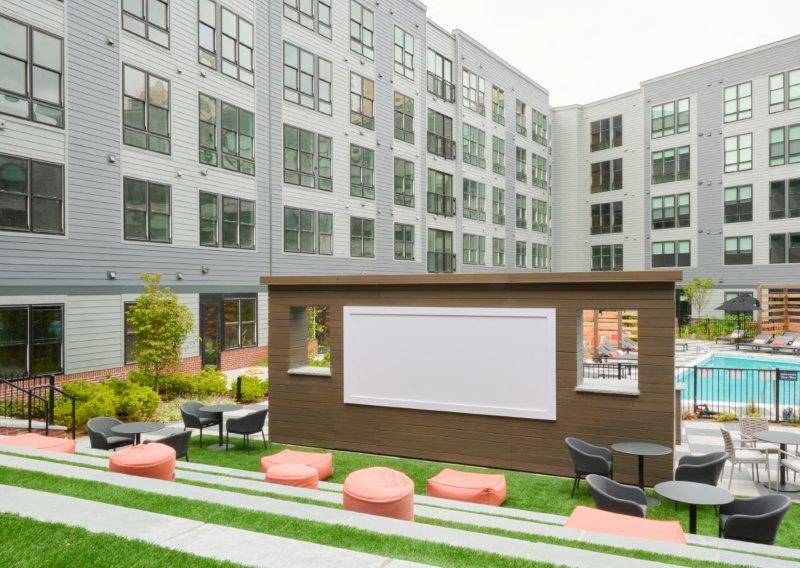a picnic area with a billboard in front of an apartment building