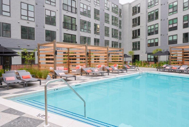a swimming pool in front of an apartment building