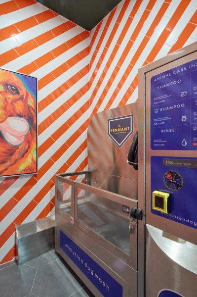 a room with an orange and white striped wall and an elevator