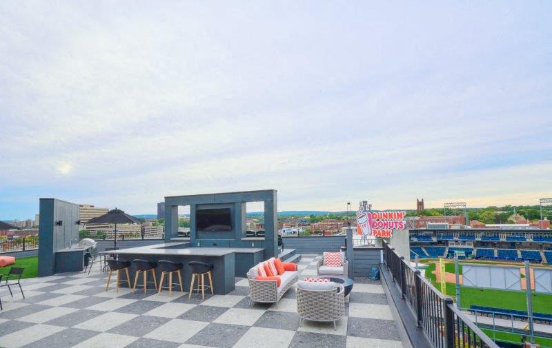 a roof terrace with a table and chairs on it
