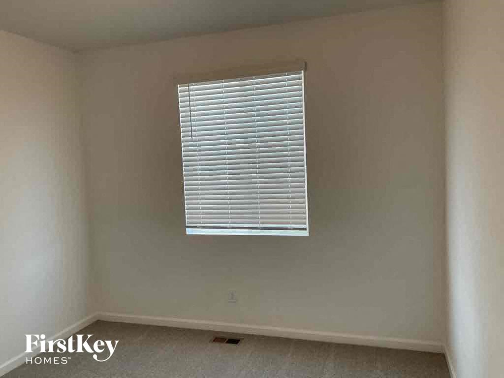 a room with a window with blinds in it