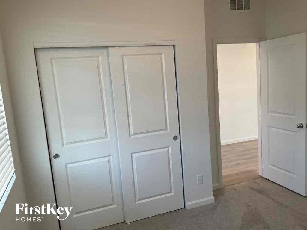 a pair of white closets in a room with a carpeted floor