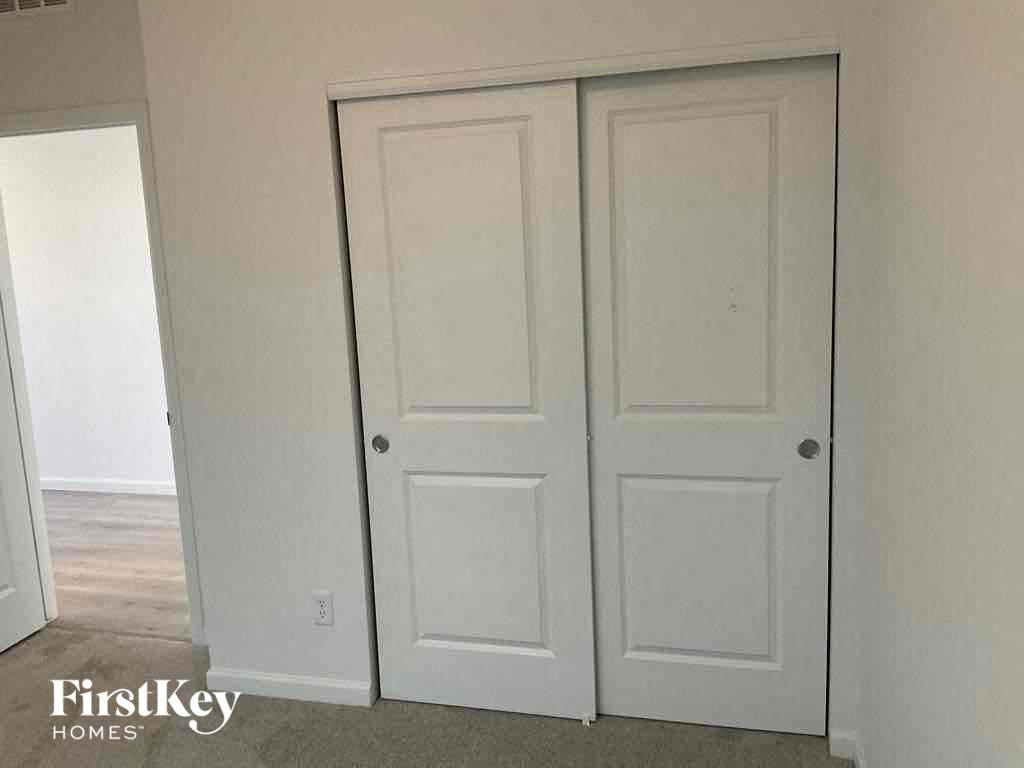 a pair of white closet doors in a room with a carpet