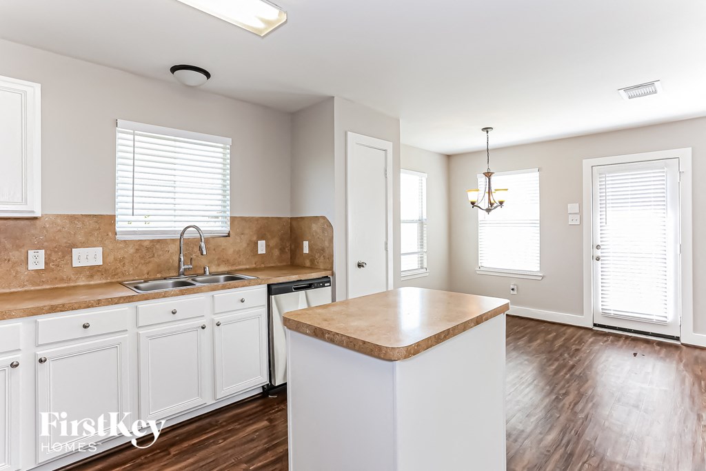 a kitchen with white cabinets and a counter top