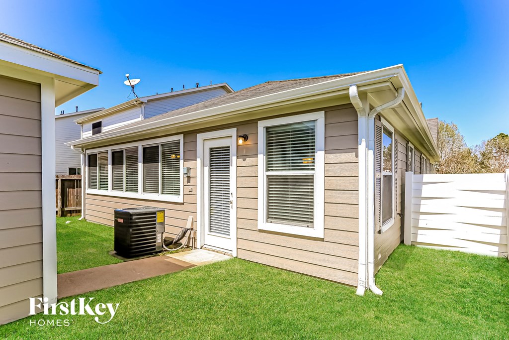 the exterior of a home with a lawn and a backyard