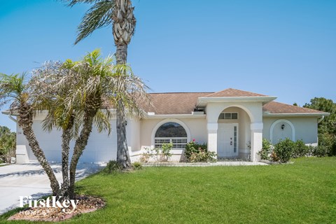 a house with a palm tree in front of it