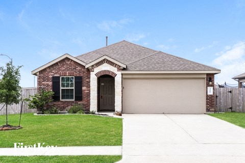 a home with a garage door and a lawn