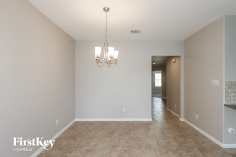 the living room and dining room with the hallway in the background