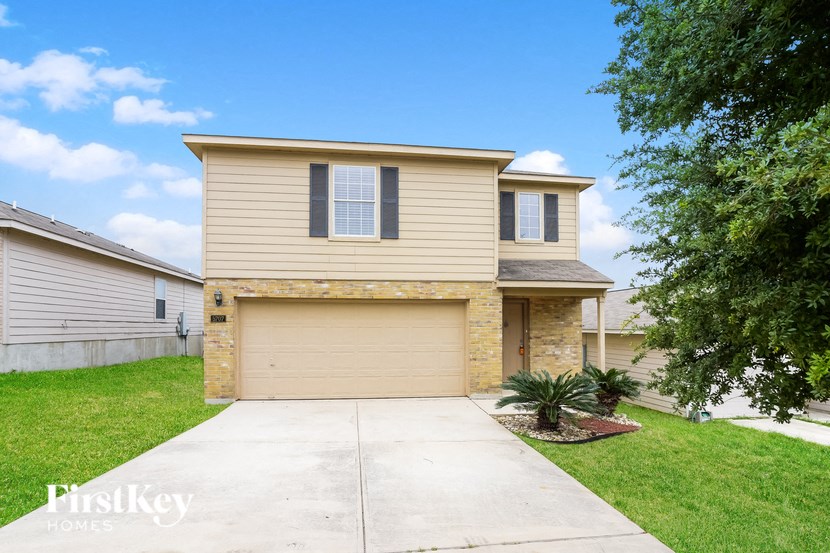 A two-story house with a garage is for sale.